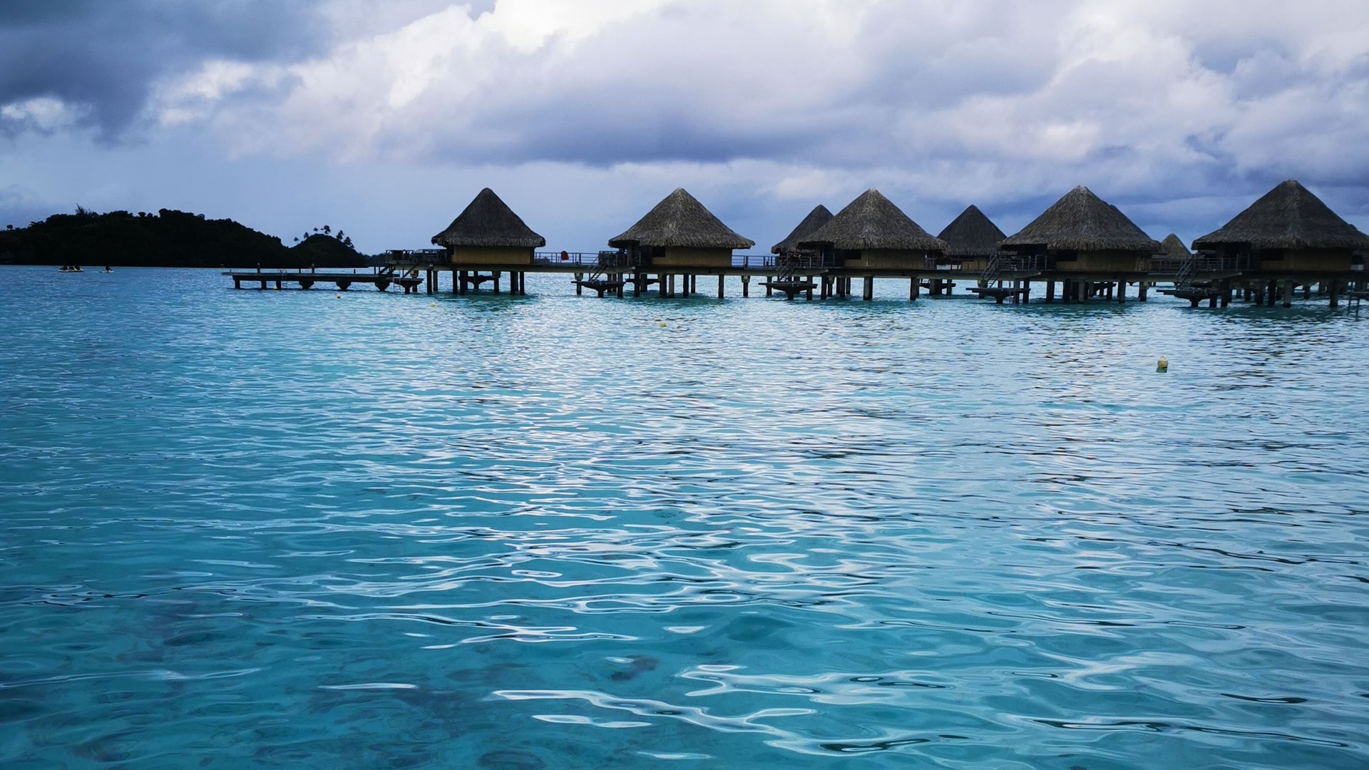 Overwater bungalows on a turquoise lagoon in Bora Bora, French Polynesia