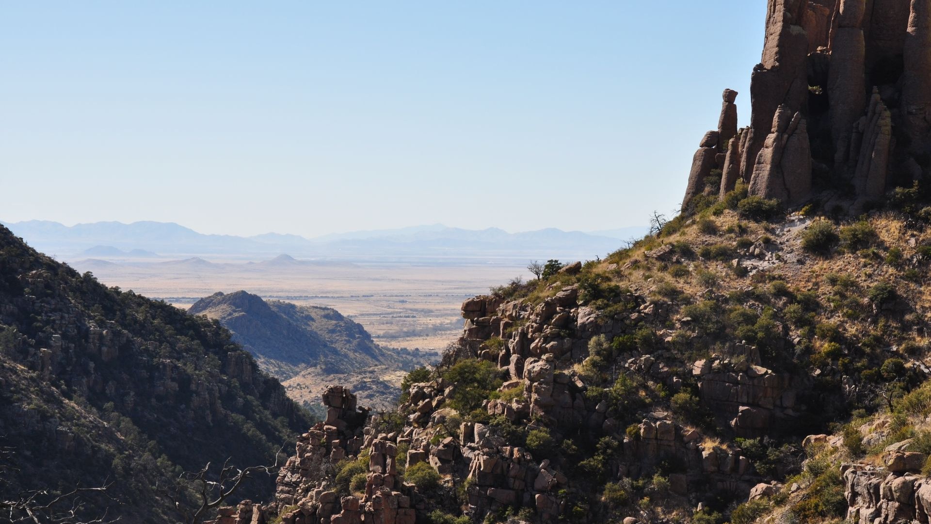 Towering rhyolite rock pinnacles of Chiricahua National Park under a clear blue Arizona sky