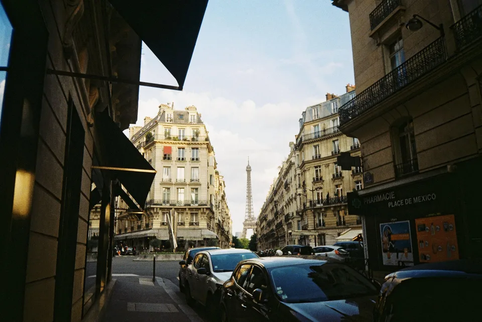 Classic Paris street with the Eiffel Tower framed by Haussmann buildings