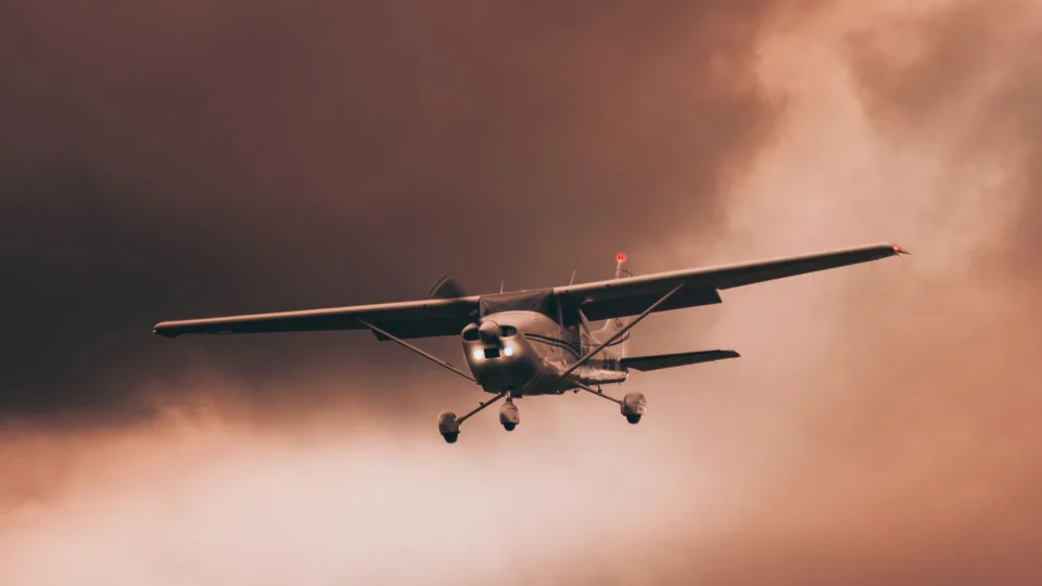 Airplane flying through dark and dramatic storm clouds