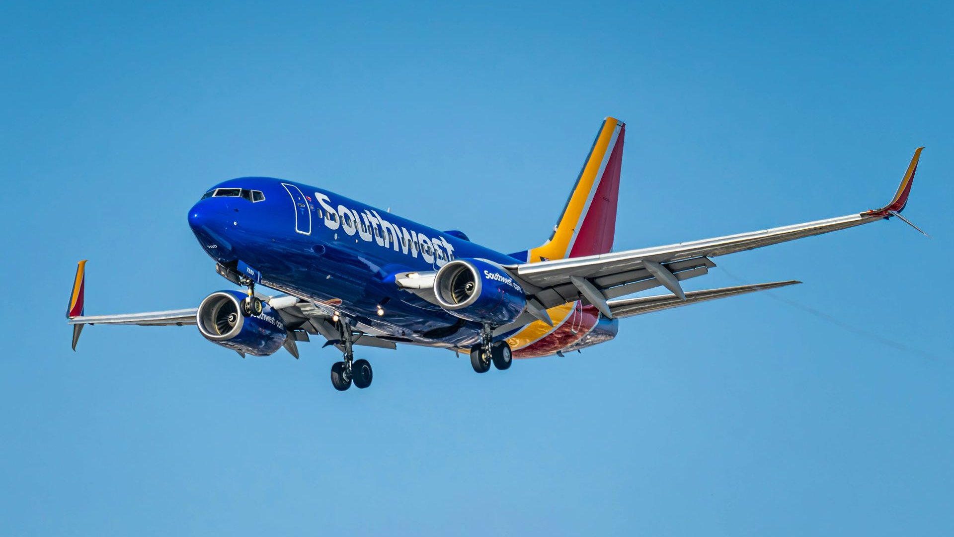 A Southwest Airlines Boeing 737 flying over Los Angeles in a clear blue sky